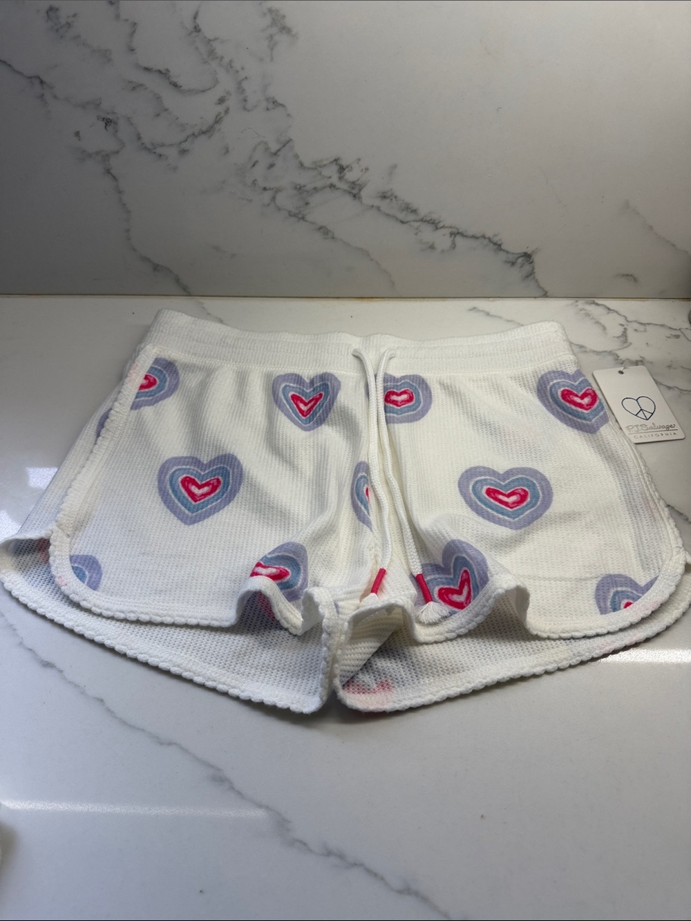 P.J. Salvage White Tag with Blue Heart-Peace Stitch Logo